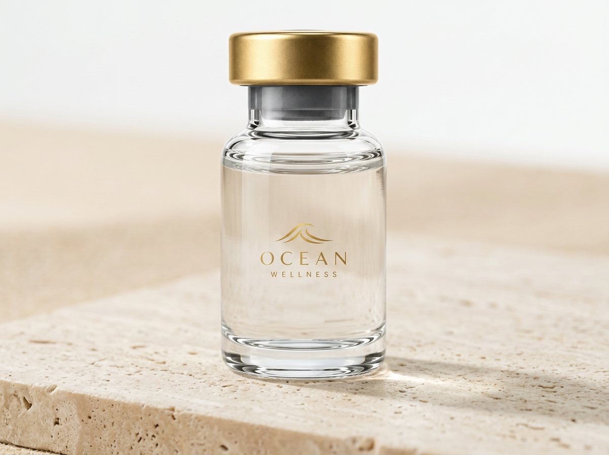 Clear glass vial with a gold cap and the Ocean Wellness gold wave logo